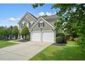 Attractive two-story home featuring a two-car garage and lush, landscaped front yard at 3635 Bardfield Ct, Cumming, GA 30041