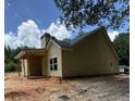 Side view of a single-story yellow home with a gray roof and covered porch at 103 New Home Rd, Rockmart, GA 30153