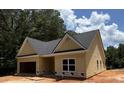 Angle view of a single-story yellow home with a gray roof and an attached garage at 103 New Home Rd, Rockmart, GA 30153