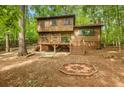 Cabin-style home featuring a deck, hammock and fire pit, ideal for outdoor relaxation at 2269 Sparrow Ridge Ne Dr, Marietta, GA 30066