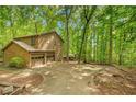 Charming cabin-style home with a two-car garage surrounded by a lush forest setting at 2269 Sparrow Ridge Ne Dr, Marietta, GA 30066