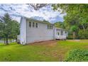 Backyard view of home, showcasing the deck, lawn, and mature trees at 2538 Morgan Lake Ne Dr, Marietta, GA 30066