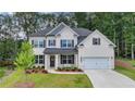 This home features a well-manicured lawn, charming shutters and an inviting porch, perfect for relaxing outside at 4056 Friendship Creek Dr, Buford, GA 30519