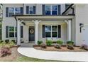 Inviting front porch with stylish seating, a welcoming wreath, and manicured landscaping for curb appeal at 4056 Friendship Creek Dr, Buford, GA 30519
