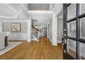 An airy foyer featuring hardwood floors, a staircase, and high ceilings at 745 Glengate Pl, Atlanta, GA 30328
