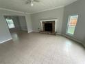 Bright living room with stone fireplace, tiled flooring, and large windows offering natural light at 1081 Forest Path, Stone Mountain, GA 30088