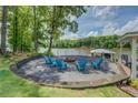 An inviting lakeside fire pit area with comfortable seating offers a perfect spot for outdoor relaxation at 22 Waters Bridge Cir, Covington, GA 30014