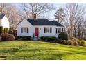 Well-maintained front yard and a charming front facade with a vibrant red door at 255 Maple Nw Ave, Marietta, GA 30064