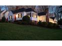 Charming home at dusk with a well-manicured lawn and bright front door at 255 Maple Nw Ave, Marietta, GA 30064