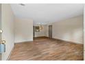 Spacious living room featuring new flooring, neutral paint, and a modern light fixture, bathed in natural light at 3152 Ridgecrest Dr, Powder Springs, GA 30127