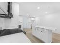 Bright, spacious kitchen features white cabinets, stainless steel appliances, and a center island at 331 Highway 162, Covington, GA 30016