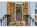 Welcoming front door with stone surround and decorative wreath at 3895 Old Atlanta Station Se Dr # 1, Atlanta, GA 30339