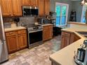 Bright kitchen featuring stainless steel appliances, tiled backsplash, and light-colored countertops at 990 Fountain Glen Dr, Lawrenceville, GA 30043