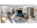 Open-concept living room boasts hardwood floors, modern furniture, and views of the dining and bath areas at 1090 Shepherds Ne Ln, Atlanta, GA 30324