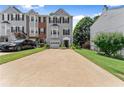 Pleasant townhome featuring driveway parking, an attached garage, and neat landscaping at 1628 Indian Way, Cumming, GA 30040