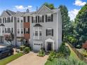 Attractive townhome featuring manicured lawn, black shutters, and a one-car garage at 1628 Indian Way, Cumming, GA 30040