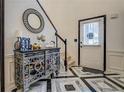 Inviting foyer boasts designer flooring, decorative mirror, and a staircase at 2587 Alvecot Se Cir, Atlanta, GA 30339