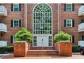 Elegant brick building entrance with a large arched window above the double doors at 302 Ridley Howard Ct # 302, Decatur, GA 30030