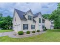 Two-story home with attached garage, manicured lawn, and symmetric shrubbery lining the walkway at 6181 E Fayetteville Dr, Riverdale, GA 30296
