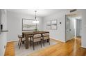 Dining room featuring hardwood floors, modern lighting, and neutral decor with an adjacent doorway at 1404 N Crossing Ne Dr, Atlanta, GA 30329