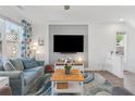 Cozy living room area with a couch, stylish decor, and a large window at 1621 Wellborn Walk, Suwanee, GA 30024