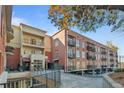 View of building exterior with multiple balconies and covered parking area in landscaped setting at 560 Dutch Vly # 02313, Atlanta, GA 30324