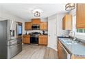 Modern kitchen featuring stainless steel appliances, wooden cabinets, and stylish lighting at 5706 Forest Pl, Acworth, GA 30102