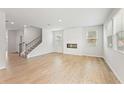 Open concept living room with wood-look floors and white shiplap fireplace at 2058 Brookhill Way, Snellville, GA 30078