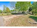 Spacious front yard with a long driveway leading to a charming single-story home with beautiful curb appeal at 144 Cathy Ln, Hiram, GA 30141