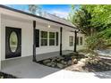 Welcoming front porch with decorative columns, stone landscaping, and a black front door at 144 Cathy Ln, Hiram, GA 30141