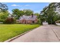 Charming brick home on a spacious lot featuring a driveway and a detached two-car garage at 407 E College E St, Bowdon, GA 30108