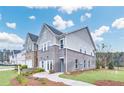 Beautiful two-story townhome with gray brick and manicured landscaping at 5753 Tillman Way, Powder Springs, GA 30127