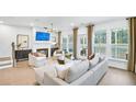 Inviting living room with fireplace, hardwood floors, and large windows at 5753 Tillman Way, Powder Springs, GA 30127