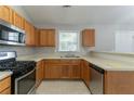 Well-lit kitchen featuring stainless steel appliances, wooden cabinets, and neutral countertops at 725 Signature Trce, Palmetto, GA 30268