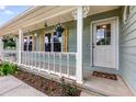 Close up of the front porch featuring white railings, hanging plants, and a welcoming front door at 107 Bowen Rd, Stockbridge, GA 30281
