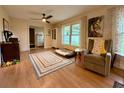 Inviting living room with hardwood floors, neutral paint, and a large window for natural light at 107 Bowen Rd, Stockbridge, GA 30281