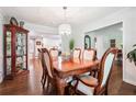 Formal dining room with wood table and chairs under decorative chandelier, open to kitchen at 1135 Timberland Se Dr, Marietta, GA 30067