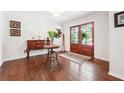 Elegant foyer features rich hardwood floors, a wooden console table, and double glass doors at 1135 Timberland Se Dr, Marietta, GA 30067