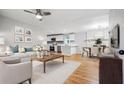 Inviting living room features a ceiling fan, hardwood floors, and an open floor plan at 3698 Sharon Dr, Powder Springs, GA 30127