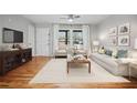 Charming living room with modern furnishings, hardwood floors, and plenty of natural light at 3698 Sharon Dr, Powder Springs, GA 30127