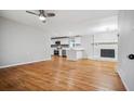 Spacious living room with hardwood floors, open floor plan, and a brick fireplace at 3698 Sharon Dr, Powder Springs, GA 30127