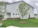 A side view shows a charming two-story home with a well-manicured lawn at 1177 Chastain Dr, Sugar Hill, GA 30518