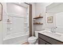 Well-lit bathroom boasts a clean design, featuring a shower-tub combo and modern vanity at 2078 Brookhill Way, Snellville, GA 30078