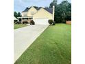 Beautiful two-story home with a well-manicured lawn and attached two car garage at 4237 Webb Meadows Dr, Loganville, GA 30052