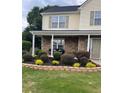 Inviting front yard with a beautiful landscape bed and decorative stone accents at 4237 Webb Meadows Dr, Loganville, GA 30052