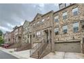 Attractive townhomes featuring brick and stone facades with attached garages and welcoming entryways at 2433 Santa Rosa St, Alpharetta, GA 30009