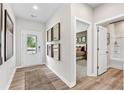 Inviting entryway with wood-look floors, stylish mirrors, and ample natural light creates a warm welcome at 2903 Sunrise Ridge Rd, Snellville, GA 30078