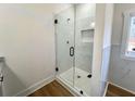 Modern bathroom showcasing a frameless glass shower with tile surround and sleek black fixtures at 6149 Pinewood Se Dr, Covington, GA 30014