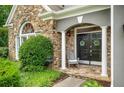 Charming entryway with stone accents, double doors, and a cozy rocking chair at 1473 Cardova Pointe, Dunwoody, GA 30338