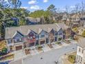 Aerial view showcasing a row of well-maintained townhomes with lush trees and street views at 2772 Archway Ln, Brookhaven, GA 30341